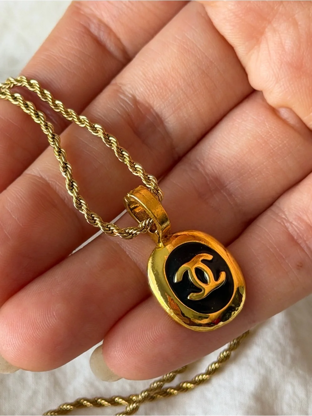 CHANEL Gold and Black Oval CC Pendant Necklace on Rope Chain